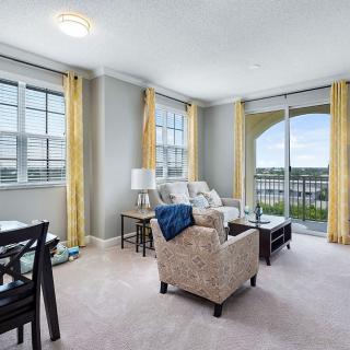 A bright and modern living room with large windows and stylish furniture.