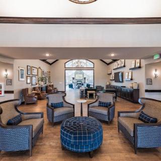 A modern lobby with a cozy seating arrangement featuring stylish chairs and decor.