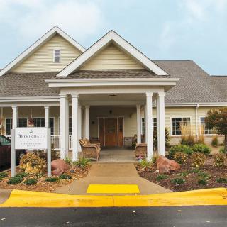 Front view of a residential-style building with landscaped surroundings and a welcoming entrance.