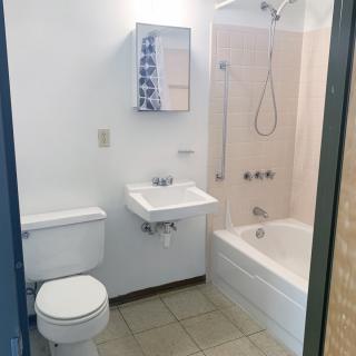 A small bathroom with a toilet, sink, and bathtub.