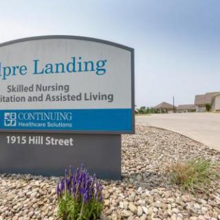 A sign for Aspire Landing, a facility offering skilled nursing and assisted living services located on Hill Street.