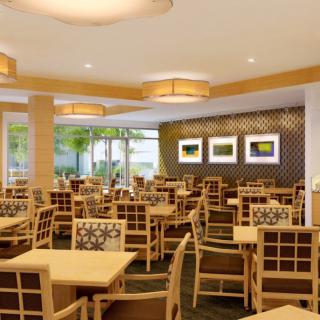 A modern restaurant dining area with neatly arranged tables and chairs.