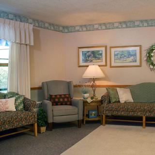 A cozy living room setup featuring comfortable seating and warm lighting.
