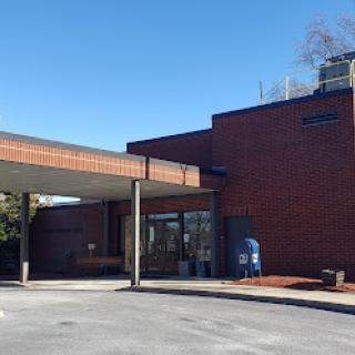 A modern brick building under a clear blue sky.