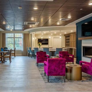 A modern and cozy living room with vibrant seating and elegant design.