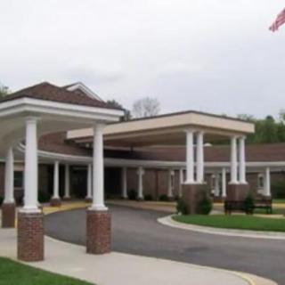 A building entrance with columns and a covered driveway.