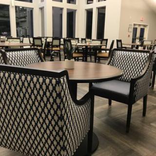 An empty dining area with neatly arranged tables and chairs.
