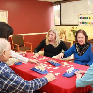 A group of people playing a table game indoors.