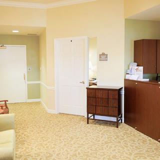 A cozy waiting room with comfortable seating and a reception desk.