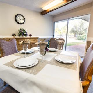 A beautifully arranged dining table with modern decor, inviting natural light.