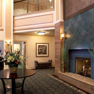 A cozy hotel lobby featuring a fireplace and elegant interior decor.