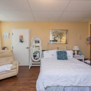 A cozy bedroom with a bed, sofa, and decorative elements.
