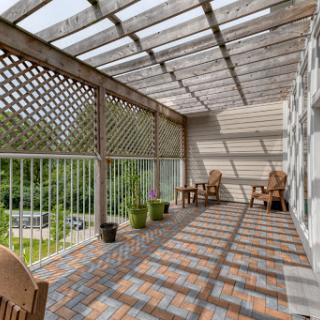 A serene balcony furnished with wooden chairs and surrounded by greenery, adorned with a lattice overhead that casts playful shadows.