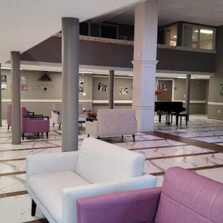 A spacious lobby with modern furnishings and a grand piano.