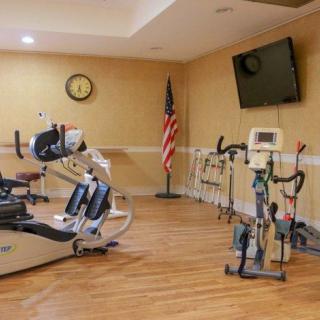 A fitness room equipped with stationary bikes and exercise machines.
