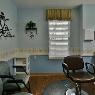 A cozy waiting room with chairs and a window.