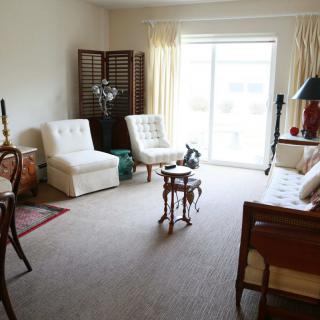 A cozy living room with elegant furniture and ample natural light.