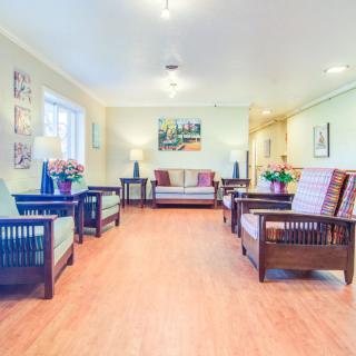 A spacious and well-lit living room with comfortable seating and elegant decor.