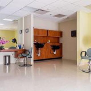 A well-organized hair salon interior with styling chairs and washing stations.