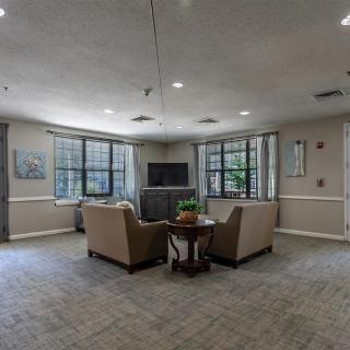 A cozy living room area with sofas and a television.
