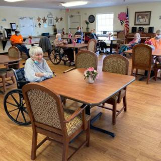 Residents enjoying their time in the activity room of a senior living facility.