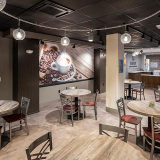 A cozy cafe interior with coffee-themed decor and wooden furniture.