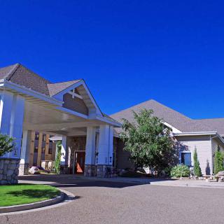Front view of a building with a covered entrance and clear blue sky.
