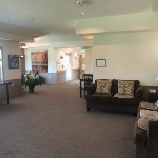A spacious and well-lit lobby with comfortable seating and decorative elements.
