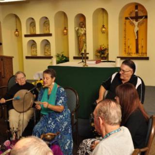 A group of people gathered in a chapel, engaging in music and singing together.