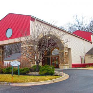 A building featuring a distinct red roof and a welcoming entrance.