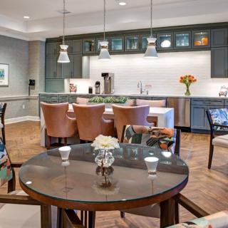 Modern open-concept kitchen and dining area with stylish decor and pendant lighting.