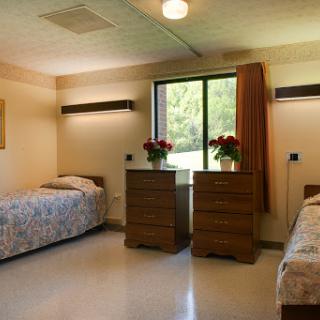 A serene hospital room with two beds, offering a comforting environment.