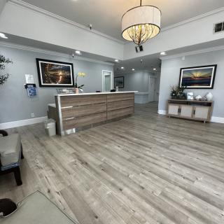 A modern reception area with a large desk and comfortable seating.