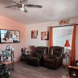 A cozy living room setup featuring a comfortable seating area and vibrant decor.