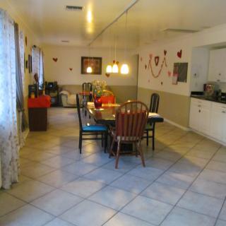 A cozy dining room with a table and chairs surrounded by decorations.