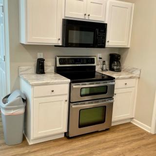 A modern kitchen setup with a stainless steel oven and microwave.