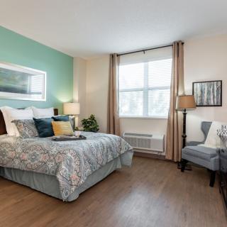A modern and well-lit bedroom with stylish decor and furnishing.