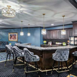 A luxurious modern bar interior with elegant seating and ambient lighting.