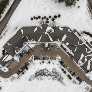 An aerial view of a building surrounded by snow, showcasing winter's serene landscape.