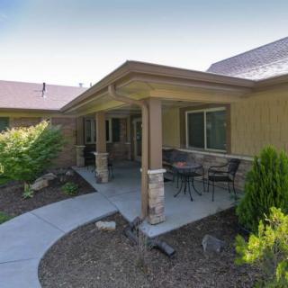 A cozy house with a covered porch and well-maintained garden.