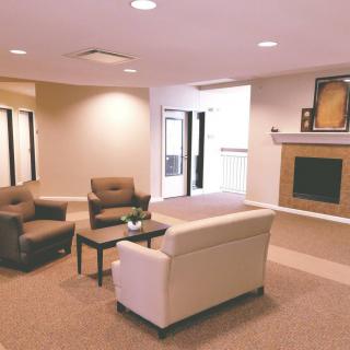 A modern living room with comfortable seating and a fireplace.