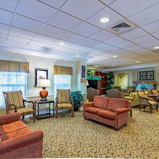 A cozy living room with comfortable seating and warm lighting.