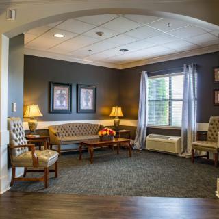 A cozy living room with comfortable seating and warm lighting.