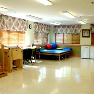 A spacious rehabilitation room equipped for physical therapy sessions.