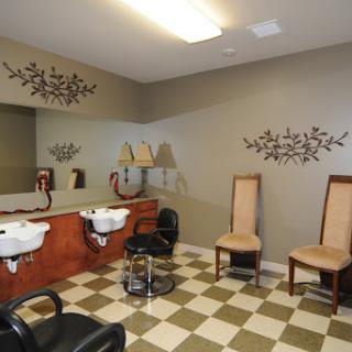 A stylish and well-organized hair salon interior featuring hair washing stations and comfortable seating.