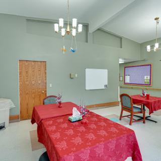 A cozy dining area featuring red tablecloths and a warm ambiance.