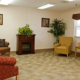 A cozy lounge area featuring comfortable seating and decorative elements.
