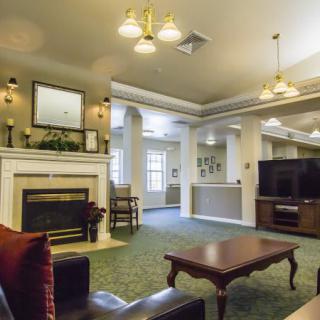 A cozy living room with a fireplace and comfortable seating.