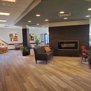 A modern lobby featuring comfortable seating and a stylish fireplace.