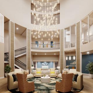 A luxurious lobby with an elegant chandelier and a comfortable seating area.